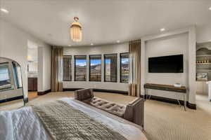 Bedroom with light carpet, connected bathroom, and recessed lighting