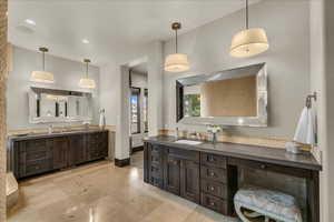 Bathroom featuring two vanities and recessed lighting