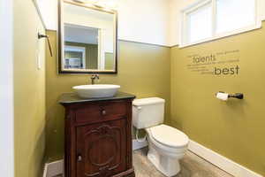 Half bathroom with vanity and light wood finished floors