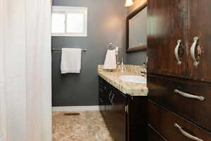 Full bathroom featuring vanity and curtained shower