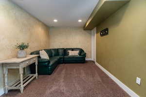 Carpeted living room featuring recessed lighting and baseboards