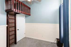 Bedroom with loft/play space and ceiling fan