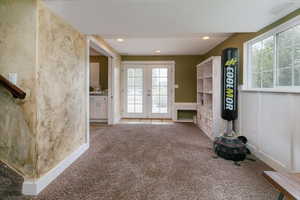 Unfurnished living room featuring carpet, french doors, and recessed lighting