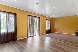 Empty room with recessed lighting, wood finished floors, and a textured ceiling