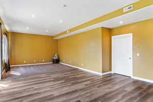 Spare room featuring recessed lighting and dark wood finished floors