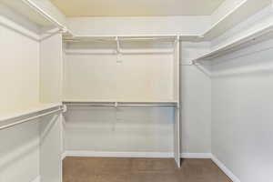 Spacious closet with dark carpet