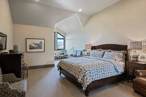 Bedroom featuring light colored carpet, high vaulted ceiling, and recessed lighting