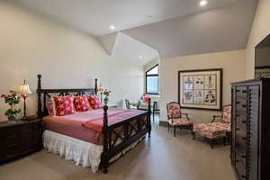 Bedroom with vaulted ceiling, light colored carpet, and recessed lighting
