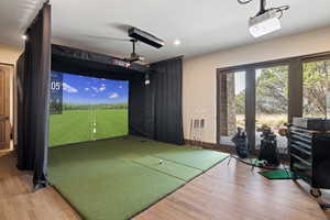 Rec room featuring golf simulator, light wood-style floors, and recessed lighting