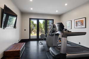 Exercise area featuring dark wood-style floors and recessed lighting