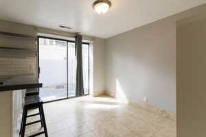 Unfurnished room featuring light tile patterned floors