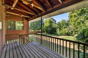 Wooden deck with view of wooded area