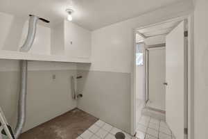 Laundry area featuring light tile patterned flooring