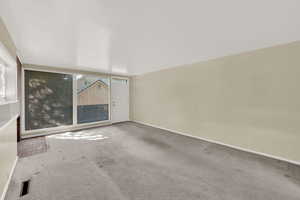 Carpeted empty room with baseboards