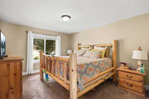 Bedroom with carpet floors and a textured ceiling