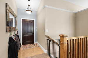 Entrance foyer featuring baseboards and light tile patterned floors