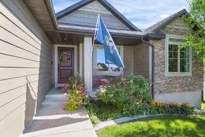 Entrance to property featuring stone siding