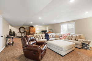 Carpeted living room featuring baseboards and recessed lighting