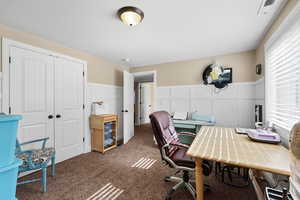 Office with a decorative wall, a wainscoted wall, and carpet floors