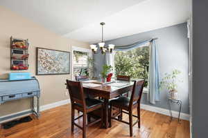 Dining space featuring light wood-style flooring and a chandelier