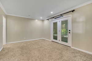 Carpeted empty room with ornamental molding and recessed lighting