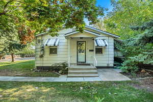 Bungalow-style home with a front lawn