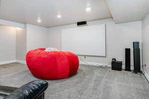 Carpeted cinema room featuring baseboards and recessed lighting