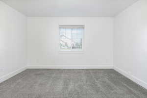 Carpeted bedroom room with baseboards