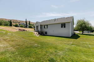 Back of property with a yard