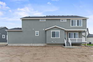 Back of house with stucco siding