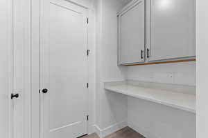 Unfurnished office featuring light wood finished floors and baseboards