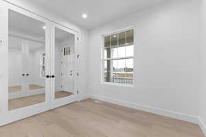 Doorway to outside with wood finished floors, recessed lighting, and french doors