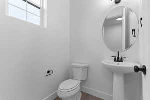 Bathroom featuring baseboards and wood finished floors