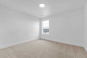 Unfurnished room with light carpet and baseboards