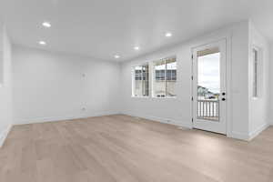 Entryway with recessed lighting and light wood-style flooring