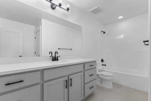 Bathroom featuring vanity, light tile patterned floors, shower / tub combination, and recessed lighting