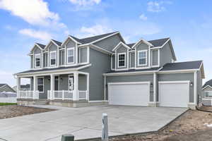 View of front of property with concrete driveway, a porch, an attached garage, and a shingled roof