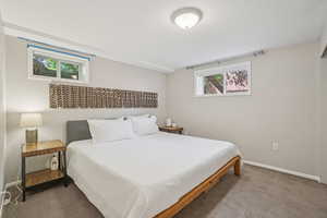 Bedroom with carpet and a textured ceiling