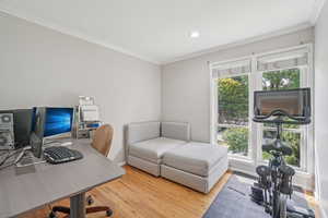 Office space with crown molding, wood finished floors, and recessed lighting