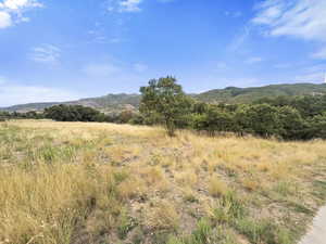 View of mountain backdrop featuring rural landscape