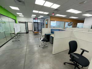 Office space featuring finished concrete floors and a drop ceiling