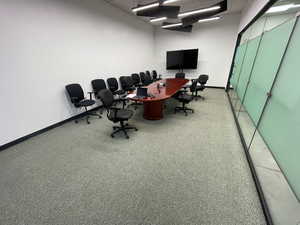 Office space with baseboards and a drop ceiling