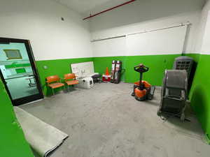 Rec room with unfinished concrete floors