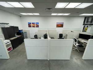 Office with concrete floors and a drop ceiling