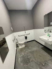 Bathroom featuring a sink and concrete flooring