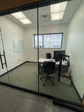 Office space featuring plenty of natural light and a drop ceiling