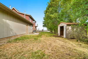 View of yard with a storage unit
