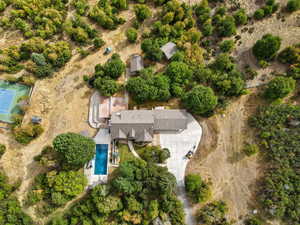 Aerial view of property and surrounding area featuring a pool area