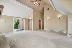 Unfurnished living room featuring high vaulted ceiling, carpet flooring, ceiling fan, and a baseboard radiator