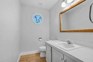 Bathroom with light wood-type flooring and vanity